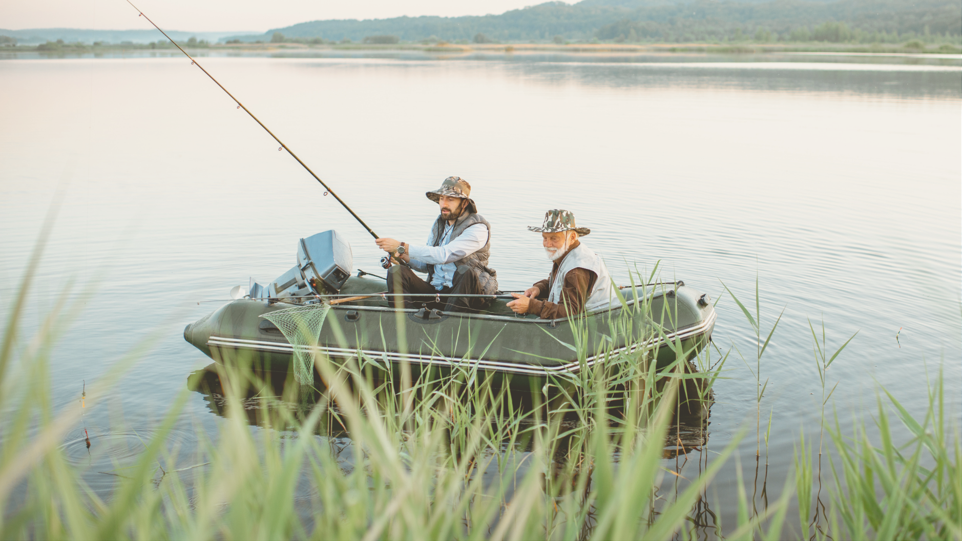 A grandfather and son fishing from a boat near their luxury RV campsite, enjoying upscale luxury RV travel.